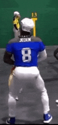 A jai alai player celebrating with a playful dance